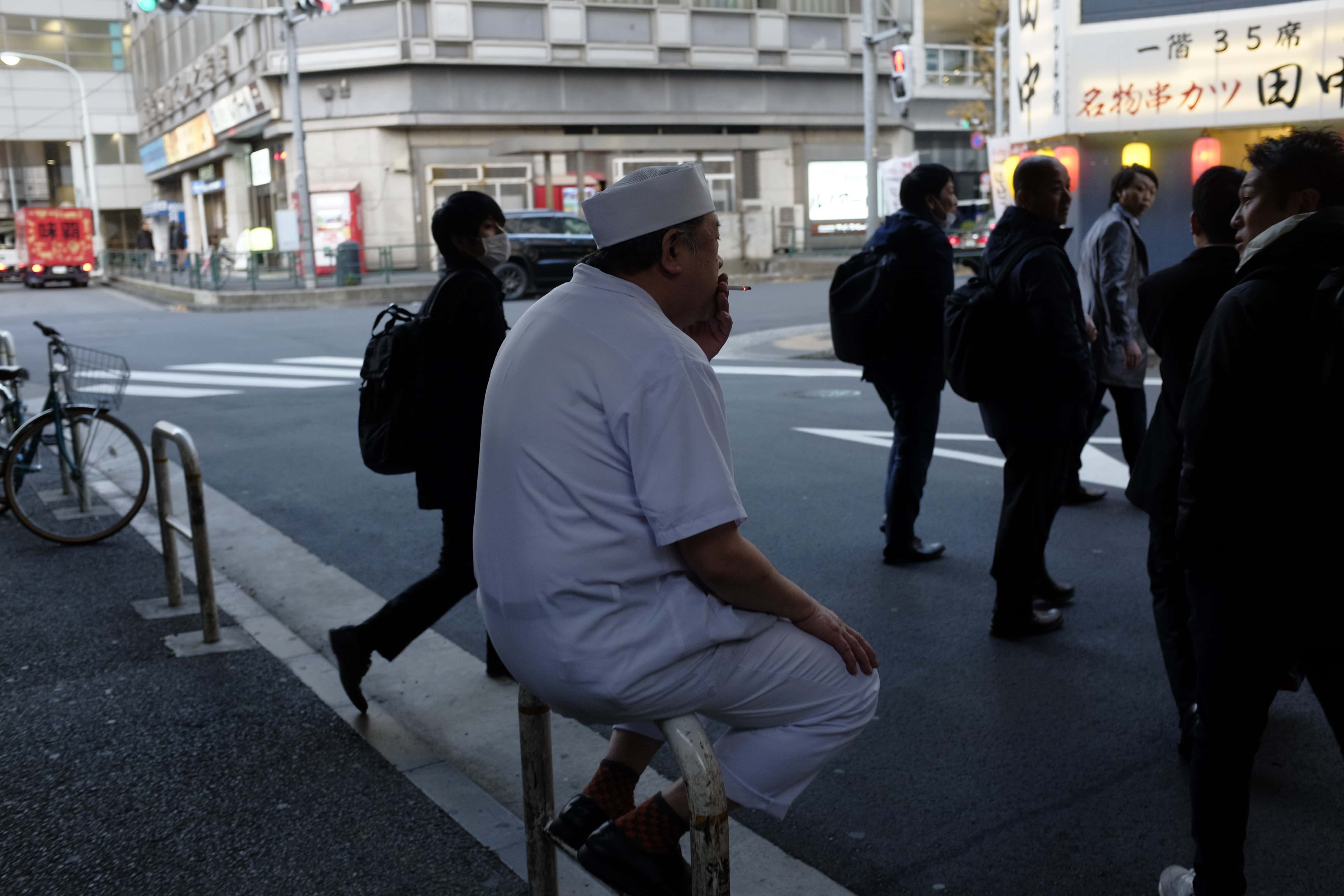 pedestrian-sitting-on-roadside